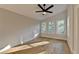Bright bedroom featuring hardwood floors and a sunroom with treetop views at 5255 Buice Rd, Alpharetta, GA 30022