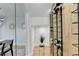 Modern wine cellar with metal racking and wood wall at 5255 Buice Rd, Alpharetta, GA 30022