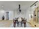 Modern dining room with hardwood floors and glass-walled wine cellar at 5255 Buice Rd, Alpharetta, GA 30022