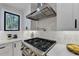 Modern kitchen with gas cooktop and hexagon backsplash at 5255 Buice Rd, Alpharetta, GA 30022