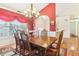 Spacious dining room, hardwood floors, and a lovely chandelier at 3709 Mcguire Nw St, Kennesaw, GA 30144