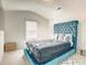 Bedroom with a teal upholstered bed and window seat at 115 Eleanora Park, Loganville, GA 30052