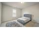 Cozy bedroom with plush carpet and gray upholstered bed at 115 Eleanora Park, Loganville, GA 30052