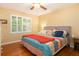 Large bedroom with hardwood floors, a king-size bed, and a ceiling fan at 2747 Townley Cir, Atlanta, GA 30340