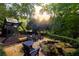 Outdoor playset and seating area near fire pit in a lush, private backyard at 4155 Flintlock Road Nw, Atlanta, GA 30327