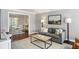 Bright living room with hardwood floors, gray sofa, and view into dining area at 11 Independence Nw Pl, Atlanta, GA 30318