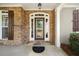 Elegant front door with arched window and stone surround at 4930 Longridge Dr, Villa Rica, GA 30180