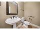 Small powder room with pedestal sink and decorative mirror at 4930 Longridge Dr, Villa Rica, GA 30180