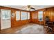 Living room with wood paneling, hardwood floors, and ceiling fan at 3024 Bob Cox Rd, Marietta, GA 30064