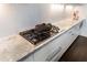 Gas cooktop with marble countertops and white cabinets at 3376 Peachtree Rd # 1, Atlanta, GA 30326