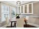 Bright dining area with wood table and four chairs, built-in white cabinets, and hardwood floors at 1078 Piedmont Ne Ave # 106, Atlanta, GA 30309