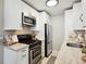 Modern kitchen with white cabinets, stainless steel appliances, and granite countertops at 1078 Piedmont Ne Ave # 106, Atlanta, GA 30309