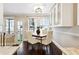 Charming dining area with a wooden table, four chairs, and access to a balcony at 1078 Piedmont Ne Ave # 106, Atlanta, GA 30309