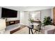 Home office with large TV, built-in shelving, and a desk at 1078 Piedmont Ne Ave # 106, Atlanta, GA 30309