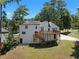 Back of two-story house, featuring deck and landscaping at 5111 Manitou Way, Stone Mountain, GA 30087