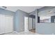 Bright hallway with light blue walls, white doors, and laminate flooring at 1467 Riverrock Trl, Riverdale, GA 30296