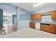 View of kitchen with wood cabinets, white appliances and laminate flooring at 1467 Riverrock Trl, Riverdale, GA 30296