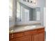 Bathroom with wood vanity, single sink, and large mirror at 1467 Riverrock Trl, Riverdale, GA 30296
