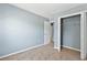 Bright bedroom with neutral walls, carpet flooring, and a large closet at 1467 Riverrock Trl, Riverdale, GA 30296
