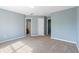 Large bedroom with carpet, neutral walls, and access to bathroom and hallway at 1467 Riverrock Trl, Riverdale, GA 30296