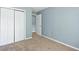 Spacious bedroom with neutral walls and carpet, double door closet and access to hallway at 1467 Riverrock Trl, Riverdale, GA 30296