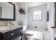 Updated bathroom with subway tile and a classic white bathtub at 3723 Debelle St, Clarkston, GA 30021