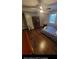 Spacious Primary bedroom with dark wood floors, TV stand, and ample room at 818 Lee Andrews Ave, Atlanta, GA 30315