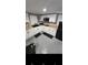 Modern kitchenette with white cabinets and black appliances at 818 Lee Andrews Ave, Atlanta, GA 30315