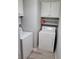 Laundry room with white washer and dryer, and overhead cabinets at 45 Caroline Ave, Stockbridge, GA 30281