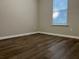 Bedroom with wood-look floors and window with blinds at 5606 Rockingwood Ct, Atlanta, GA 30349