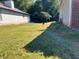 Side yard with a grassy area and partial view of neighboring house at 5606 Rockingwood Ct, Atlanta, GA 30349