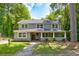 Two-story house with a covered porch and manicured lawn at 174 Rivertown Rd, Fairburn, GA 30213