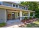 Charming front porch with hanging plants and landscaping at 174 Rivertown Rd, Fairburn, GA 30213