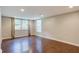 Large finished basement room with hardwood floors and natural light at 174 Rivertown Rd, Fairburn, GA 30213