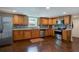 Modern basement kitchen featuring wood cabinets and granite countertops at 174 Rivertown Rd, Fairburn, GA 30213