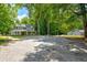 Renovated two-story house with spacious gravel driveway, and detached building at 174 Rivertown Rd, Fairburn, GA 30213