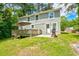 Deck and patio area with a smoker and lush green lawn at 174 Rivertown Rd, Fairburn, GA 30213