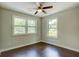 Bedroom with hardwood floors and two windows at 174 Rivertown Rd, Fairburn, GA 30213