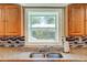 Clean kitchen sink with granite countertop and wood cabinets at 174 Rivertown Rd, Fairburn, GA 30213