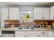 Kitchen with granite countertops and double sink at 5223 Hollyfield Dr, Stone Mountain, GA 30088