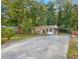 Ranch house with a long driveway and mature trees at 398 Cologne Se Dr, Atlanta, GA 30354