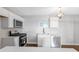 Modern kitchen with white cabinets, stainless steel appliances, and hardwood floors at 398 Cologne Se Dr, Atlanta, GA 30354