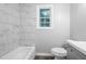 Clean bathroom with a bathtub and marble-look tile at 398 Cologne Se Dr, Atlanta, GA 30354