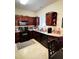 Efficient kitchen with dark wood cabinets and modern appliances at 2555 Flat Shoals Rd Apt # 3305, College Park, GA 30349