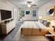 Virtually staged main bedroom with a king-size bed, and neutral decor creating a restful environment at 5120 Lower Elm St, Atlanta, GA 30349