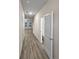 Long hallway with light gray walls and wood-look flooring leading to other rooms, offering convenient access at 5120 Lower Elm St, Atlanta, GA 30349