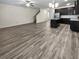Open living room and kitchen with gray wood-look flooring, creating a spacious and modern feel at 5120 Lower Elm St, Atlanta, GA 30349