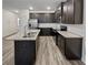 Modern kitchen with dark cabinets, granite countertops, and stainless steel appliances at 5120 Lower Elm St, Atlanta, GA 30349