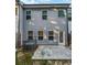 Rear view of a townhouse showcasing a private patio and concrete slab, providing outdoor space at 5120 Lower Elm St, Atlanta, GA 30349