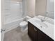 Clean bathroom with a tub, toilet and dark brown vanity at 5120 Lower Elm St, Atlanta, GA 30349